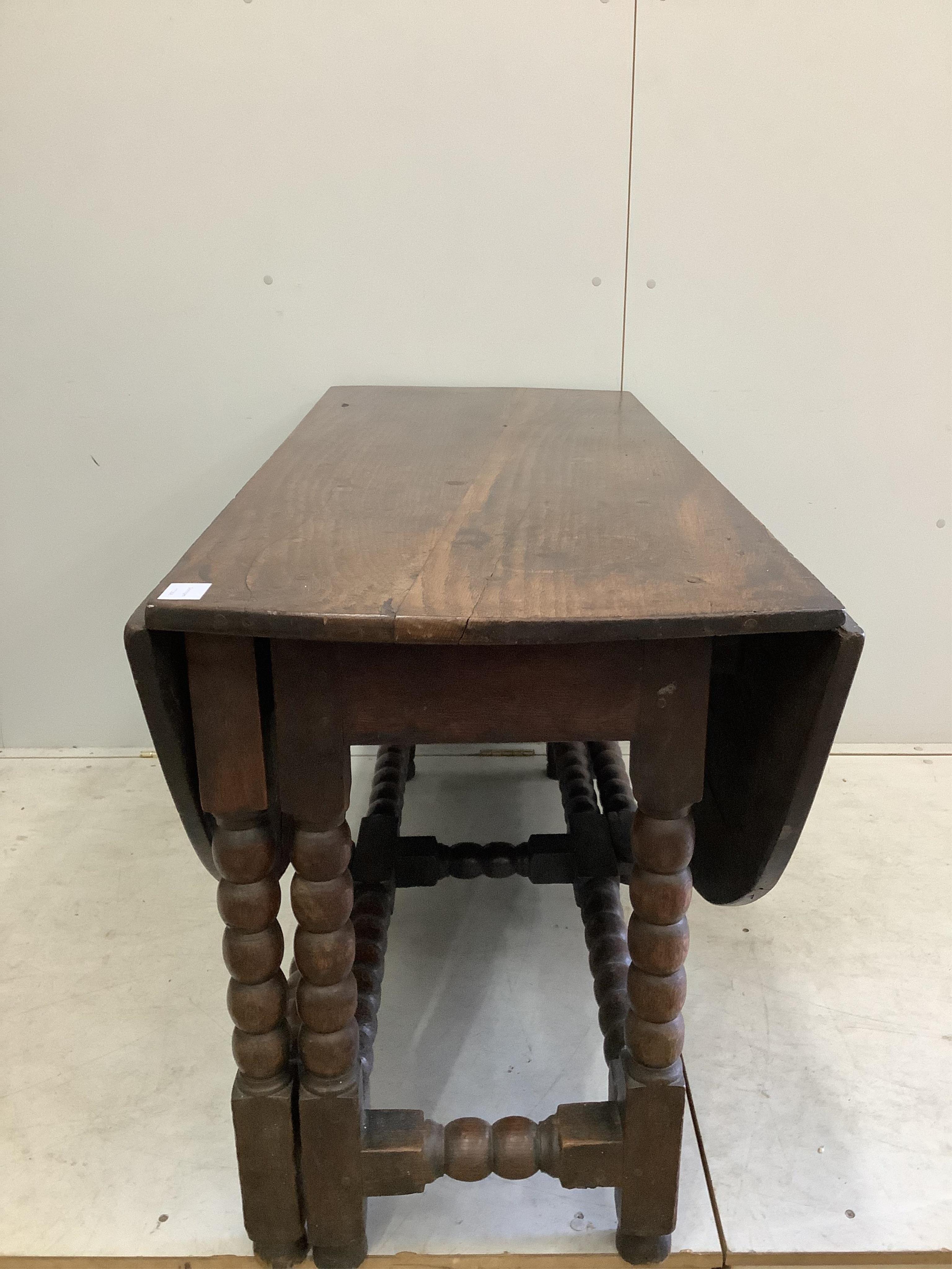 An 18th century oak gateleg table, width 122cm, depth 56cm, height 72cm. Condition - poor to fair